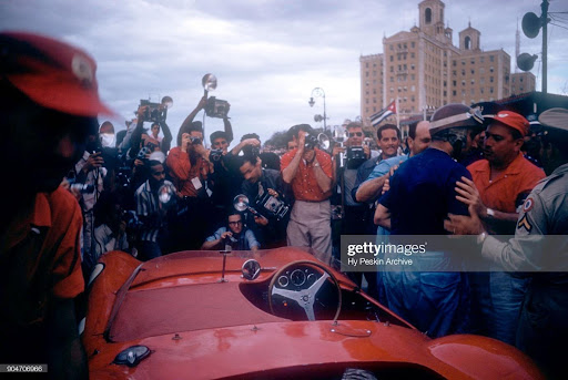 Juan Manuel Fangio climbs out of his Maserati 300S