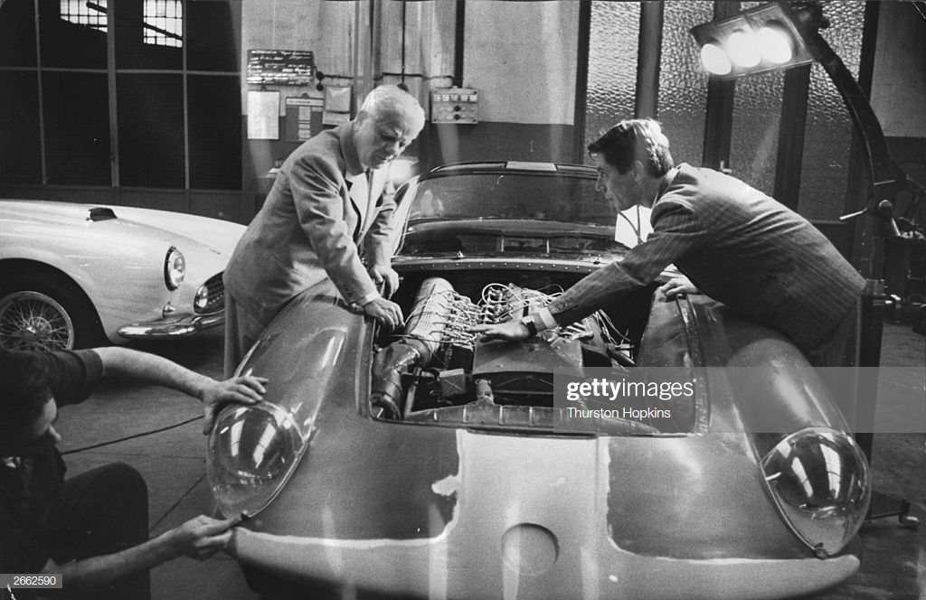 Italian car designer Battista Farina and his son examine the engine