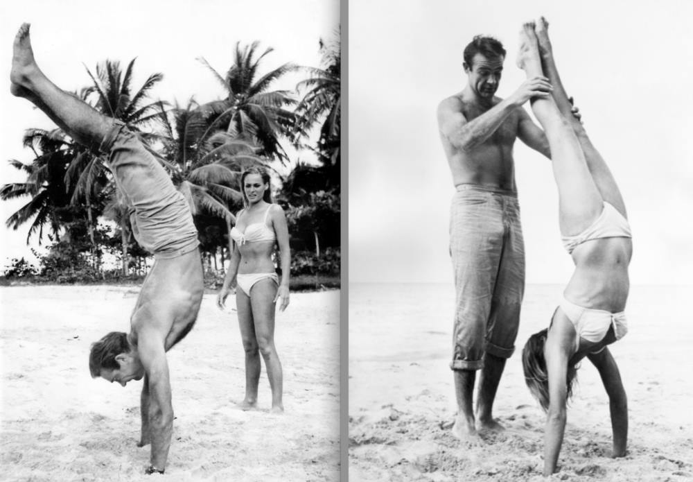 Sean Conner teaches handstands to Ursula Andress