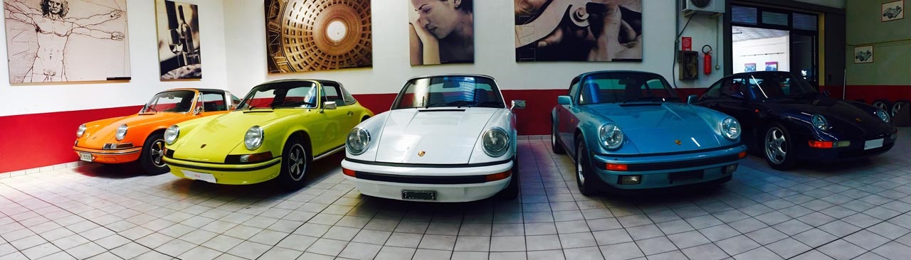 5 Porsches inside the car dealer.