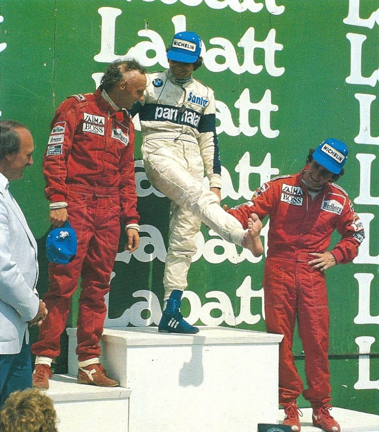 Nelson Piquet, on the podium of the 1984 Canadian Grand Prix, shows his foot burned due to a fault with the radiator of his Brabham.