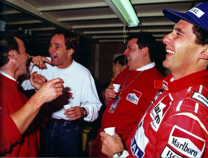 Gerhard Berger and Ayrton Senna laughing happily.