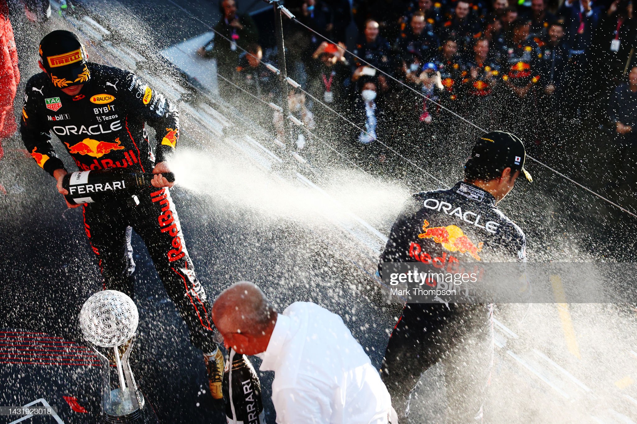 Max Verstappen and Sergio Perez celebrate on the podium.