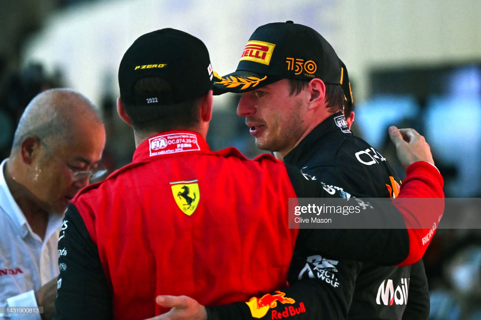 Max Verstappen and Charles Leclerc celebrate on the podium.
