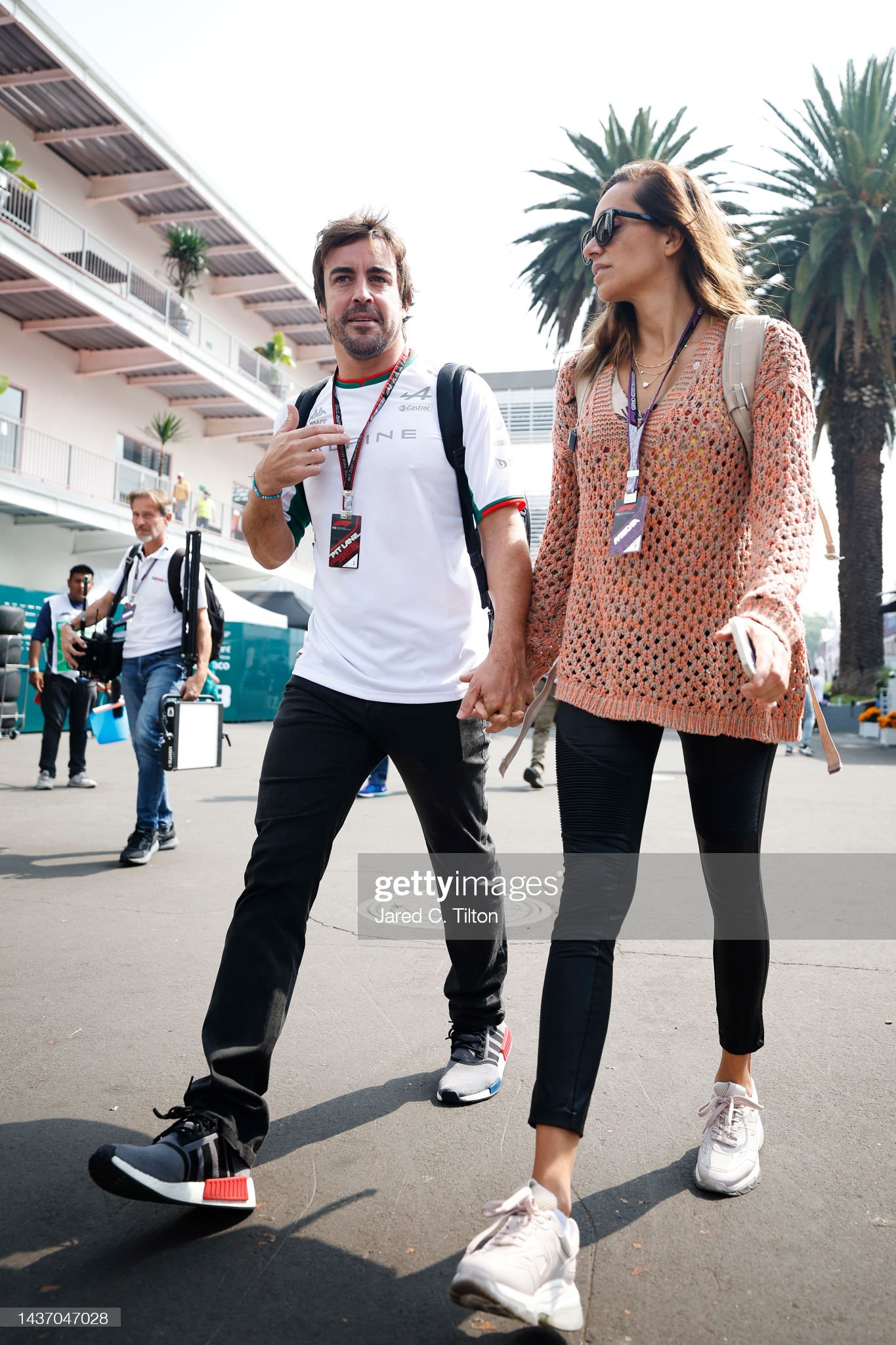 Fernando Alonso of Alpine F1 walks in the paddock with Andrea Schlager.