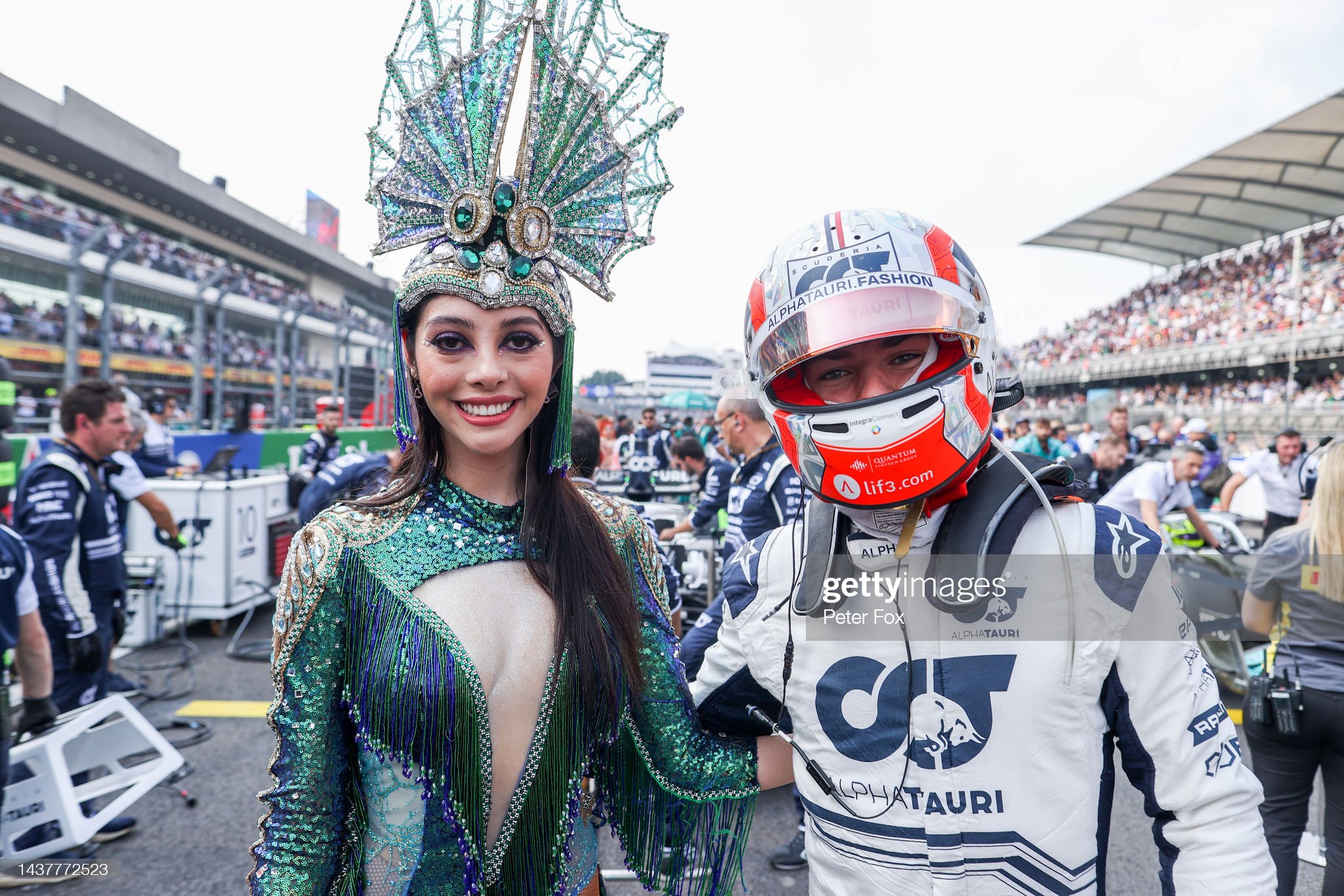 Pierre Gasly with a female performer on the grid.