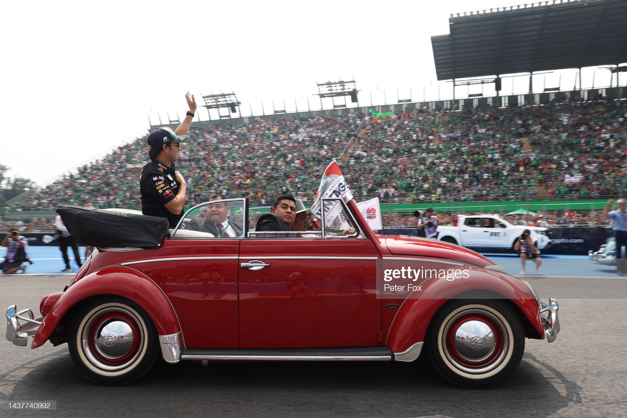 Sergio Perez of Mexico and Red Bull Racing waves to the crowd on the drivers’ parade.