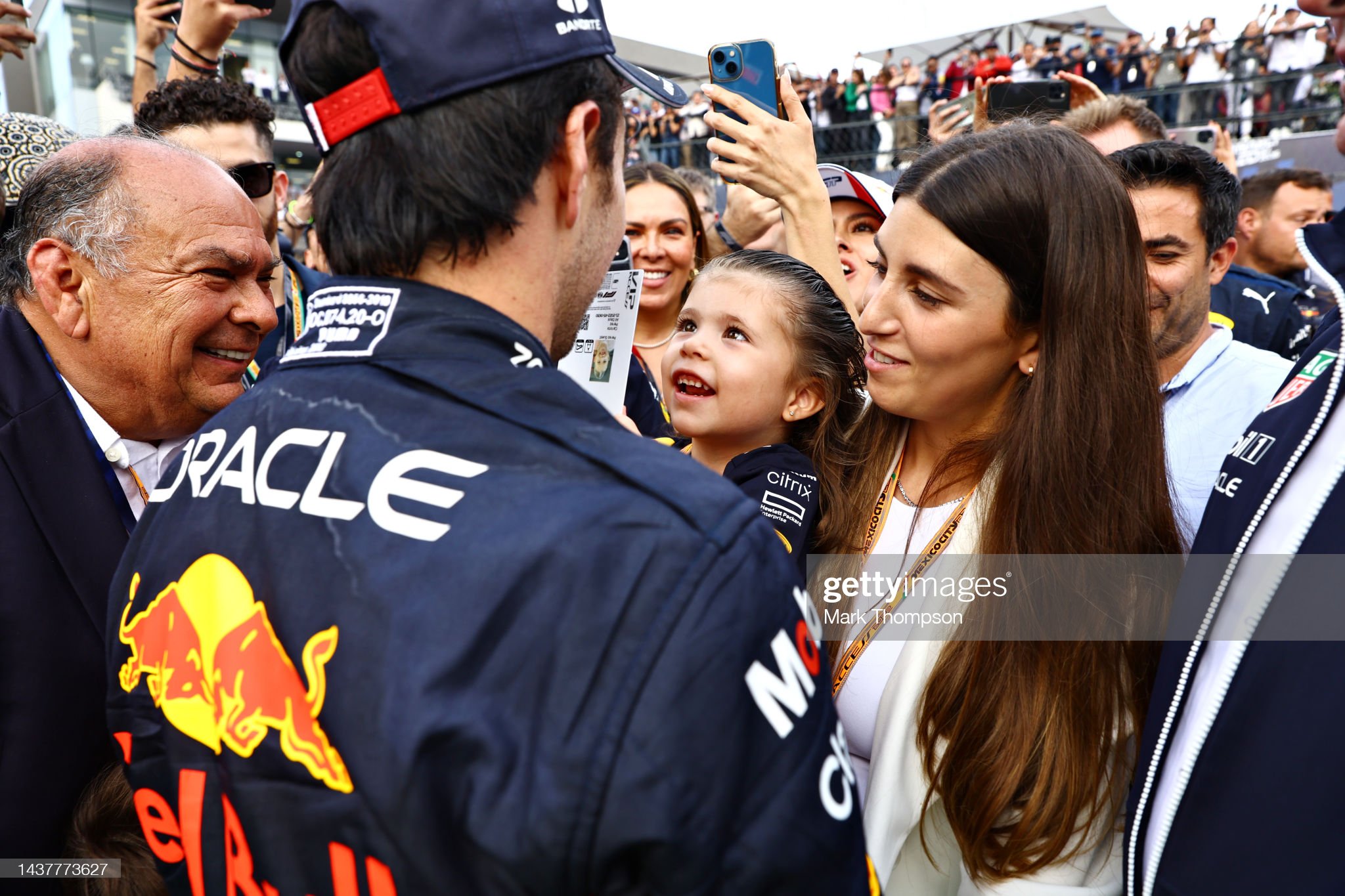 Third placed Sergio Perez of Mexico and Red Bull Racing celebrates with his family in parc ferme during the F1 Grand Prix.