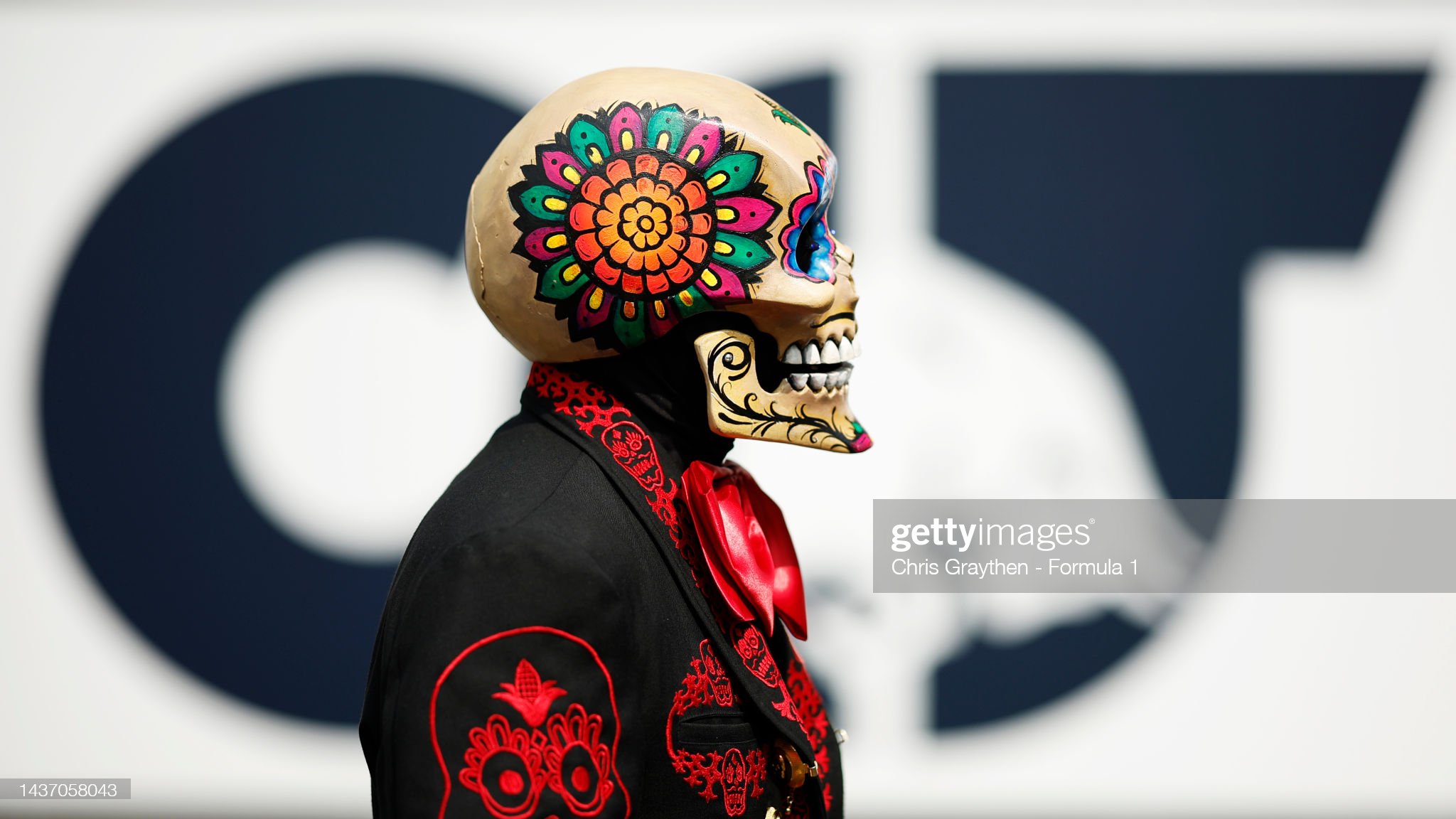 A Day of the Dead performer looks on in the Paddock.