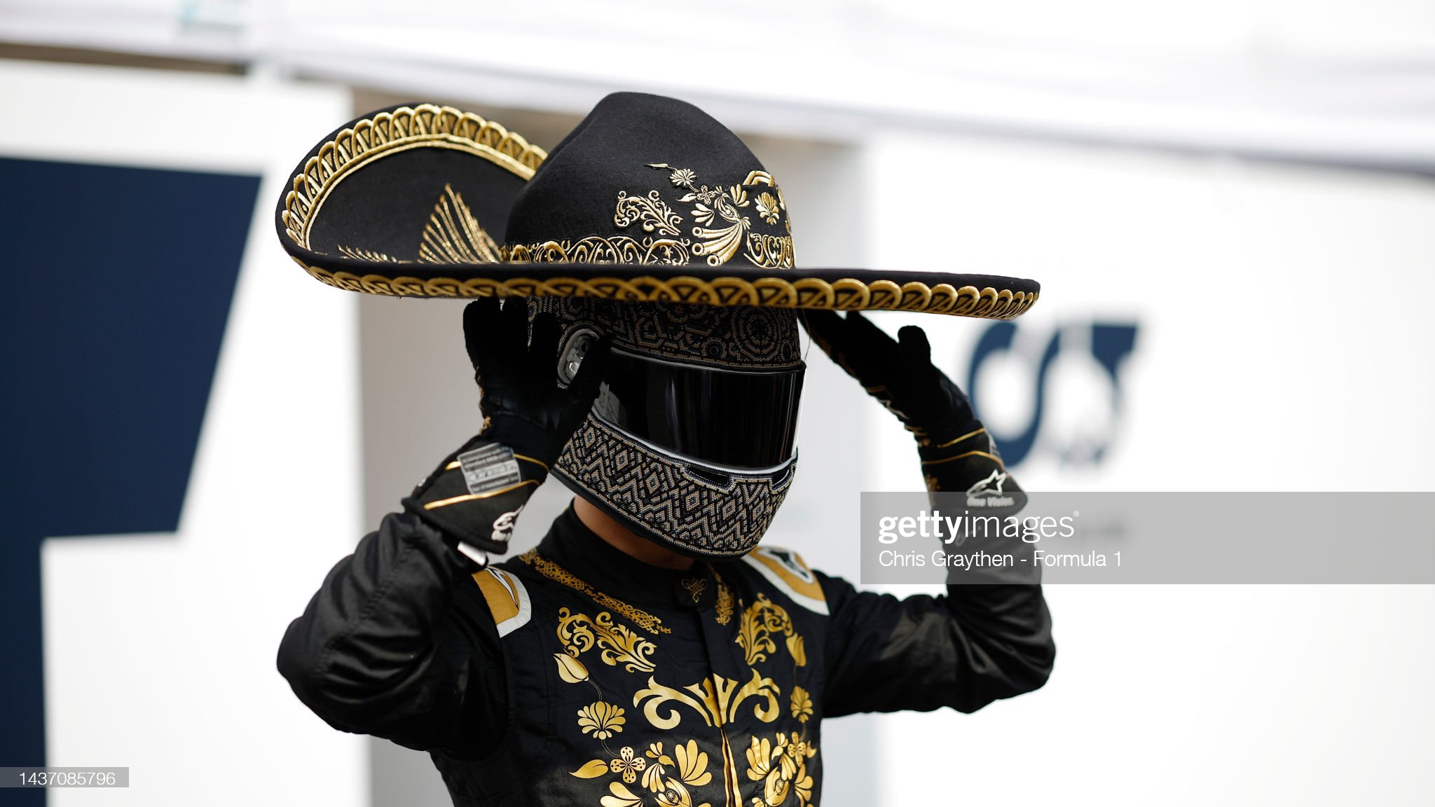 Pierre Gasly of AlphaTauri, dressed as Mario Achi, wears a sombrero in the paddock.