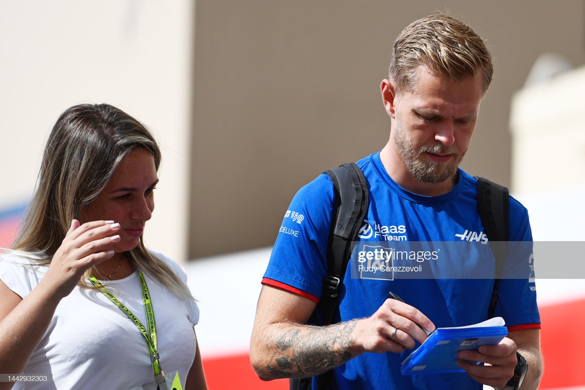 Kevin Magnussen of Denmark and Haas signs an autograph in the paddock.
