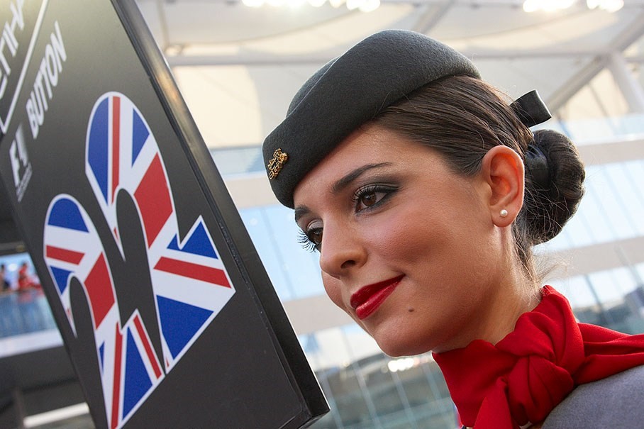 An Etihad Airways stewardess holds Button's number board at Abu Dhabi in 2009. 