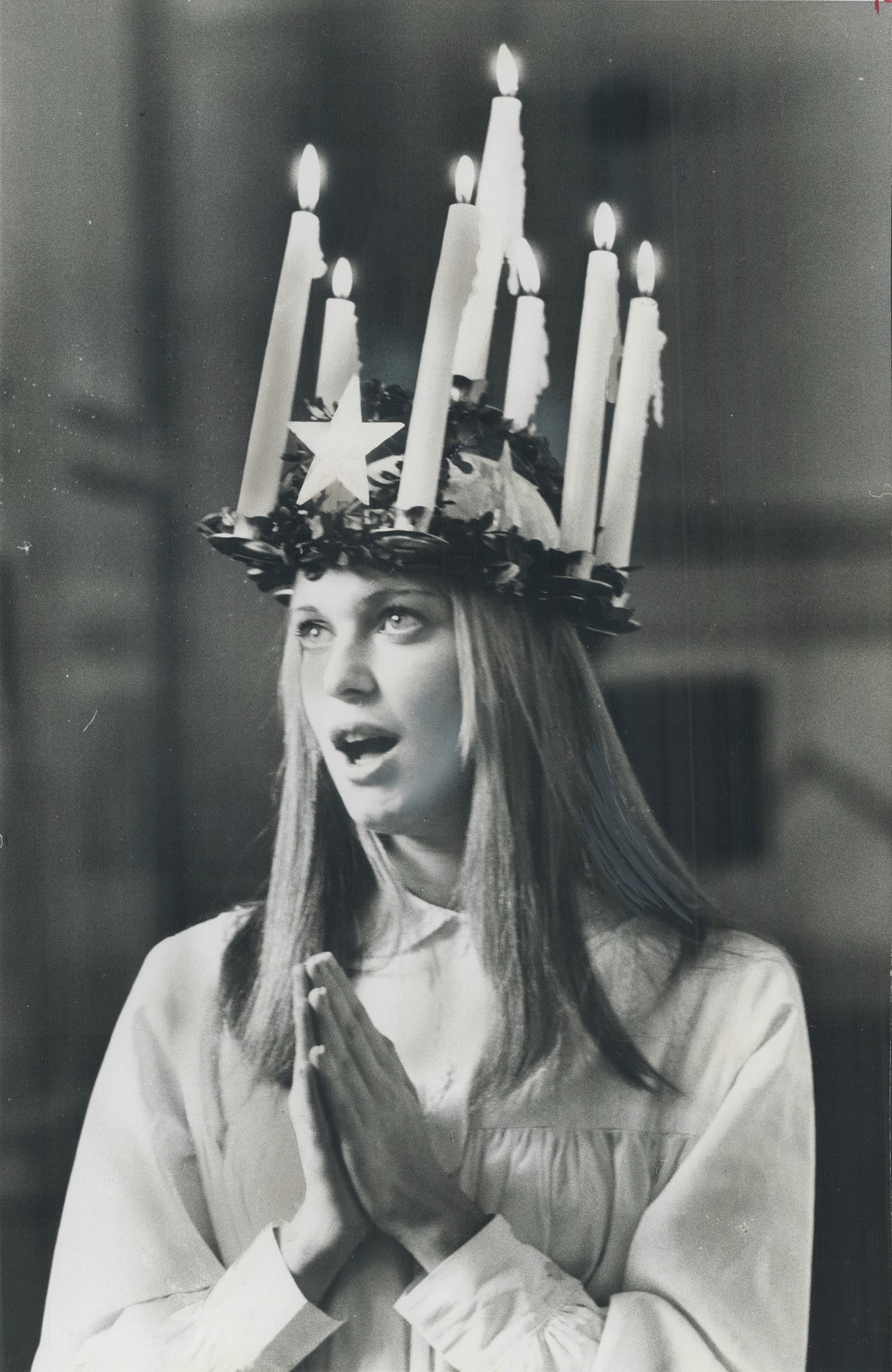 A Christmas 'Crown of candles'. Marking the annual Lucia Day festival of lights, 19-year-old Anne Marie Peterson of Stockholm, Sweden wears a crown of candles after being crowned Queen of Light by the Scandinavian-Canadian Club at Queen's Park.