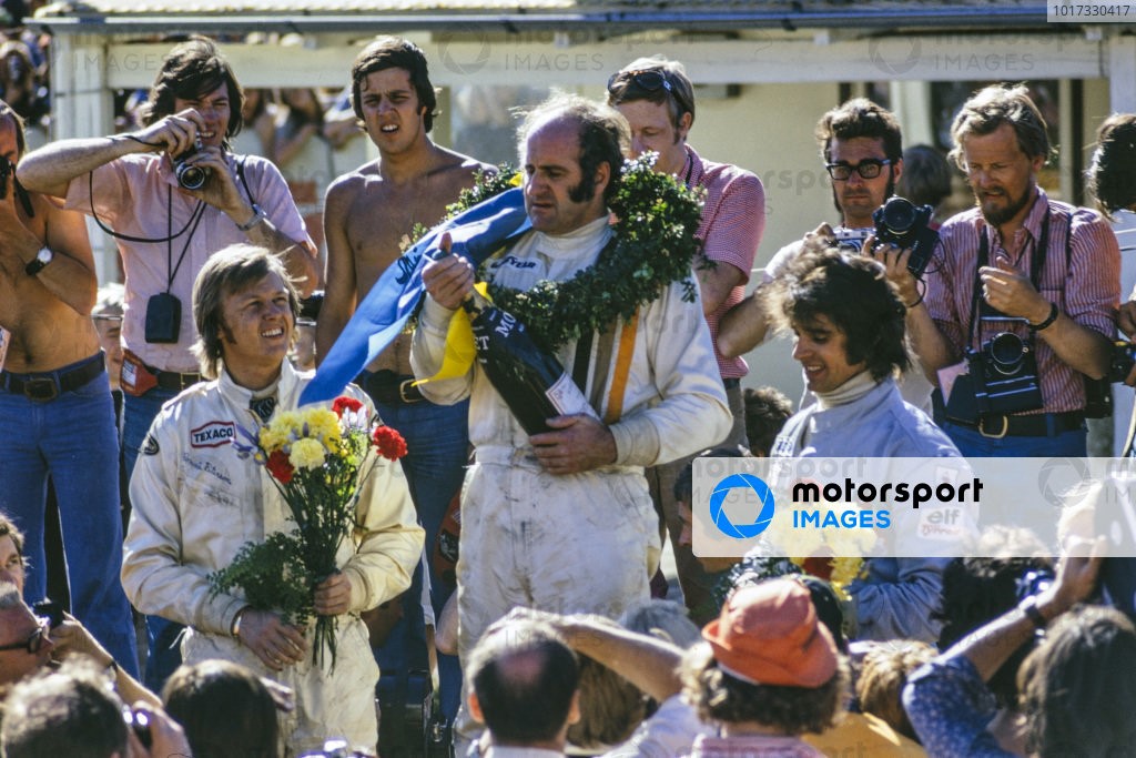 Winner Denny Hulme celebrates victory with Peterson, 2nd position and Francois Cevert 3rd position in 1973.