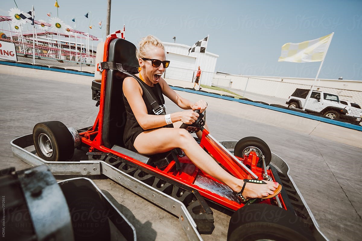 A blonde girl in a kart.