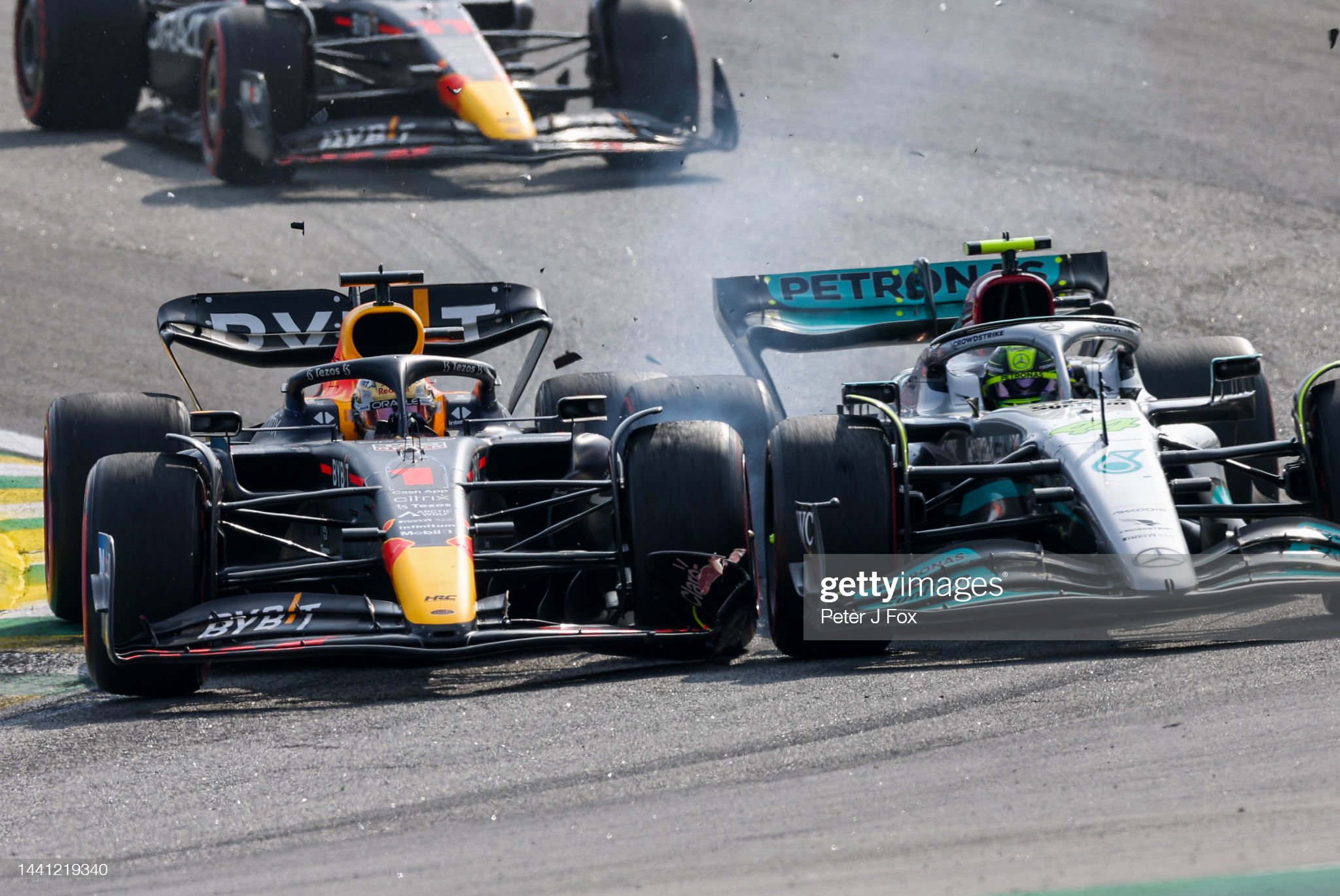Max Verstappen of Red Bull Racing and The Netherlands and Lewis Hamilton of Mercedes and Great Britain clash at turn 2 during the F1 Grand Prix of Brazil.