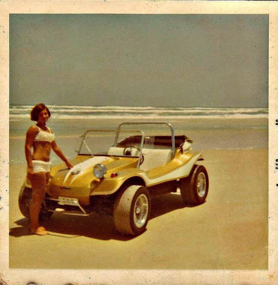A girl in a bikini and a yellow Dune Buggy.