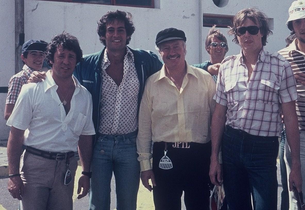 Colin Chapman with Mario Andretti, random punter, Ronnie Peterson and interesting belt.