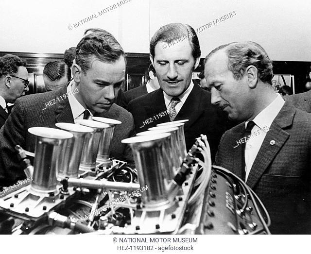 Graham Hill, pictured in the centre, with Colin Chapman.