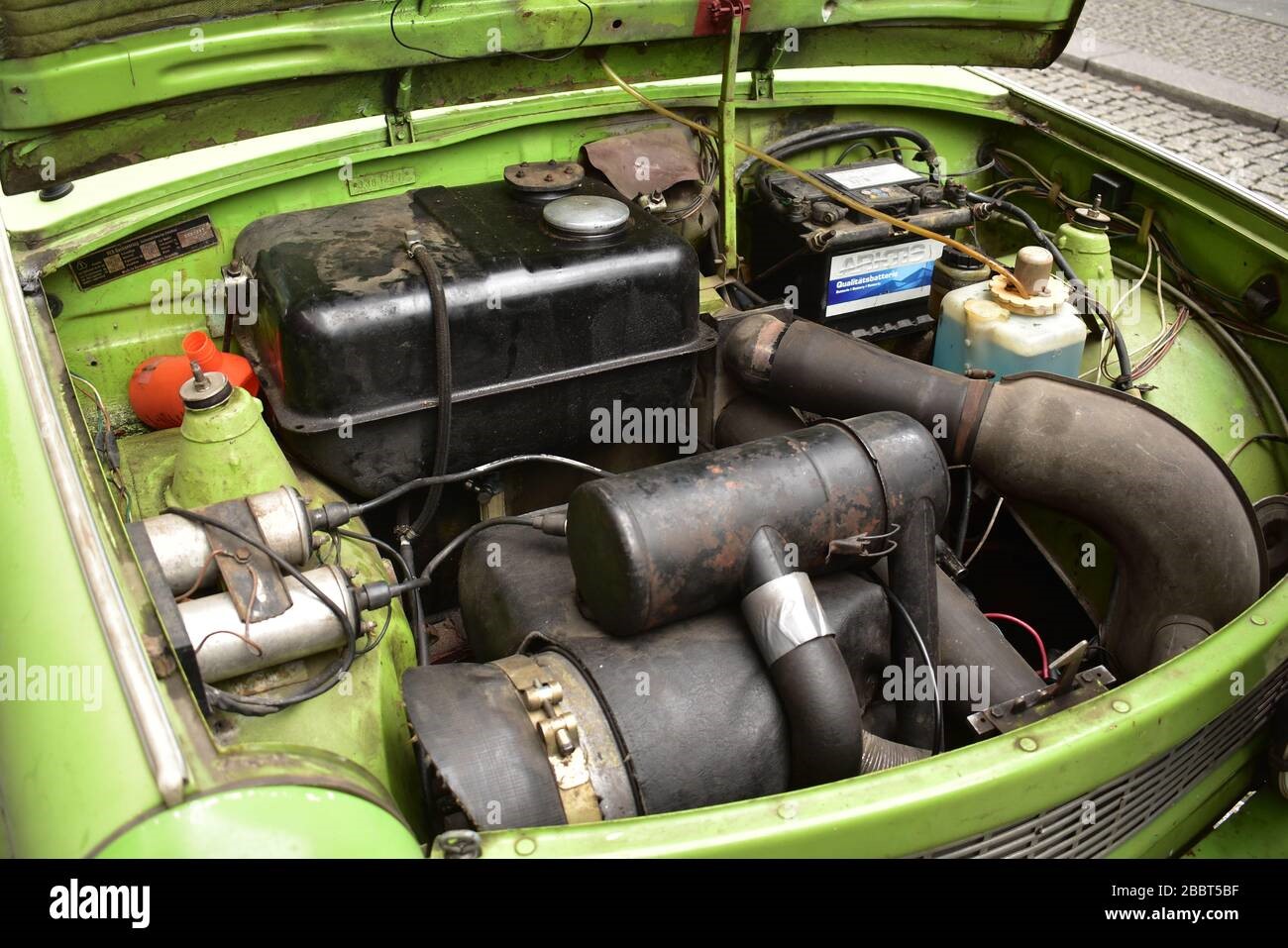 The open front hood of a green Trabant.