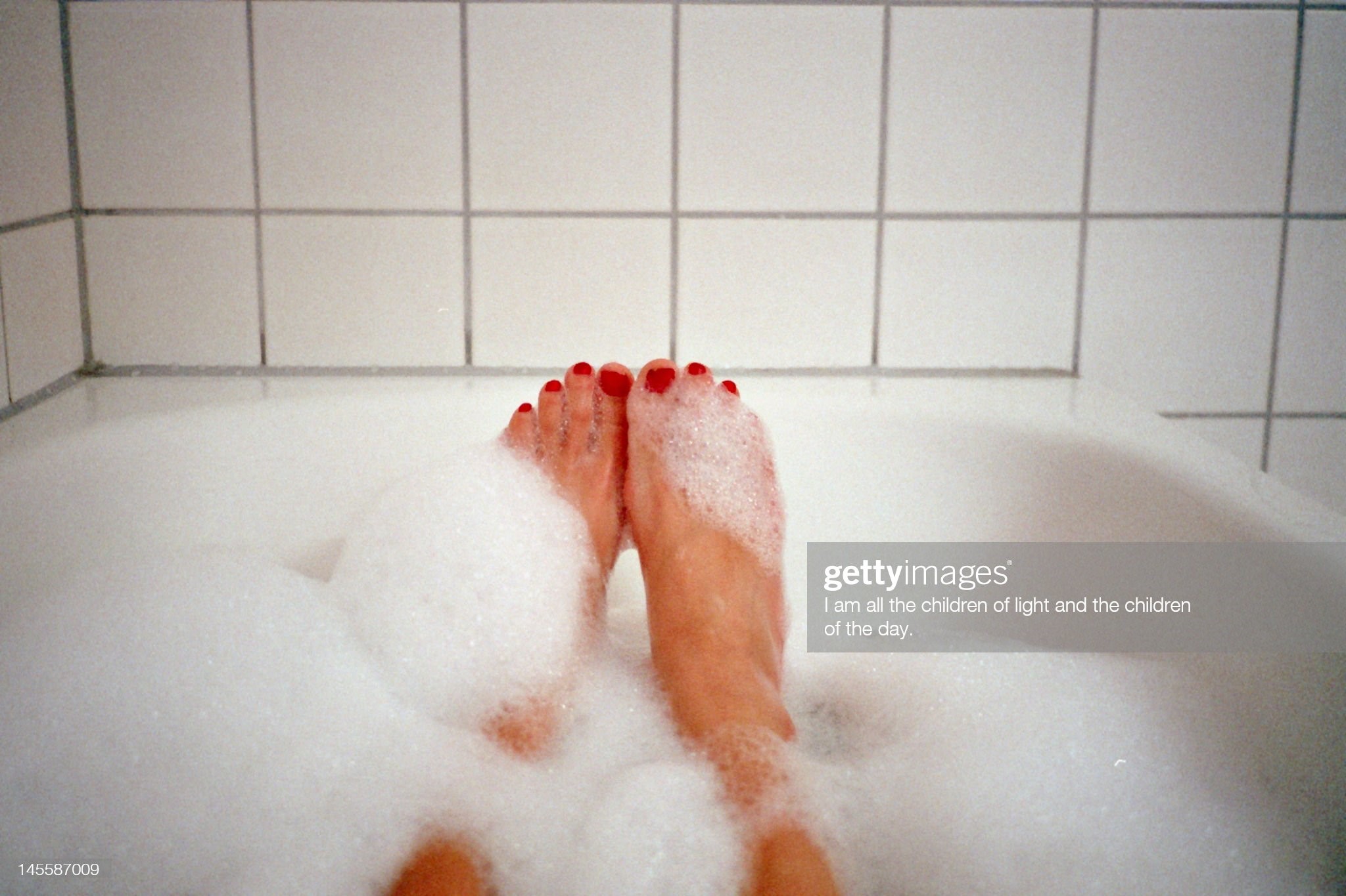 German woman's leg inside bathtub.
