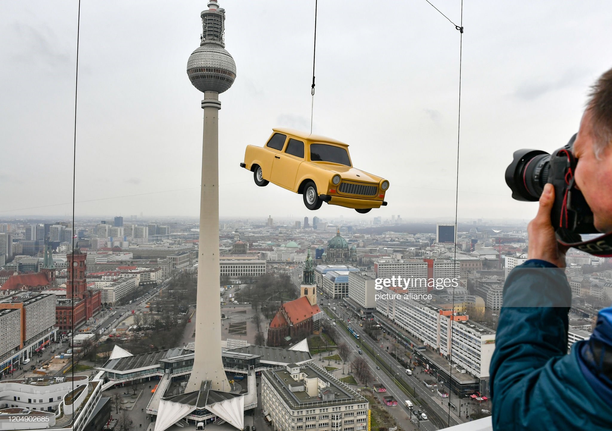 A replica Trabant hangs at the Park Inn Hotel at the Base Flying facility above Alexanderplatz with a view over the city centre of Berlin, on March 03, 2020. 