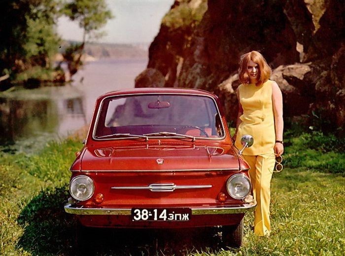 A girl beside a Russian car.
