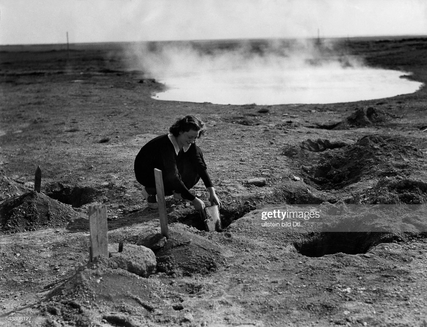 Icelandic woman bread baking in a 'Zinnkasten' near by a geyser in 1935. 