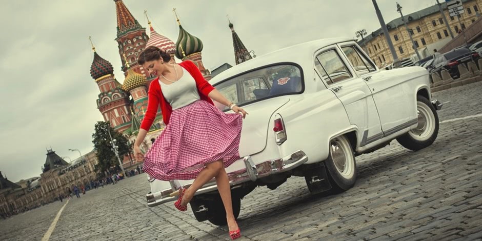In retro style photo shoot with a Russian beauty and a Soviet car.
