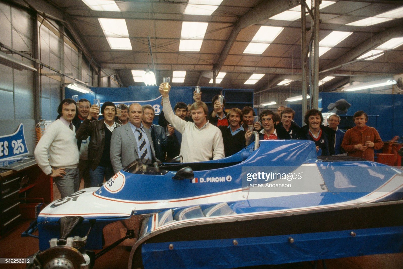 Didier Pironi celebrates victory in the Belgian Grand Prix in Zolder with Guy Ligier (striped tie) and Jacques Laffite (right) with mechanics from the Ligier team.