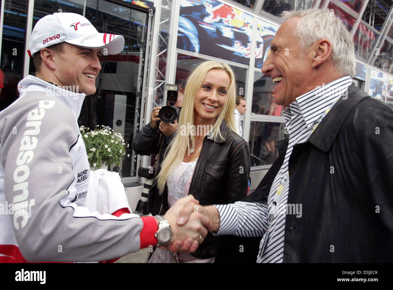 Austrian billionaire Dietrich Mateschitz greets German Formula One driver Ralf Schumacher of Toyota and his wife Cora Schumacher with a handshake
