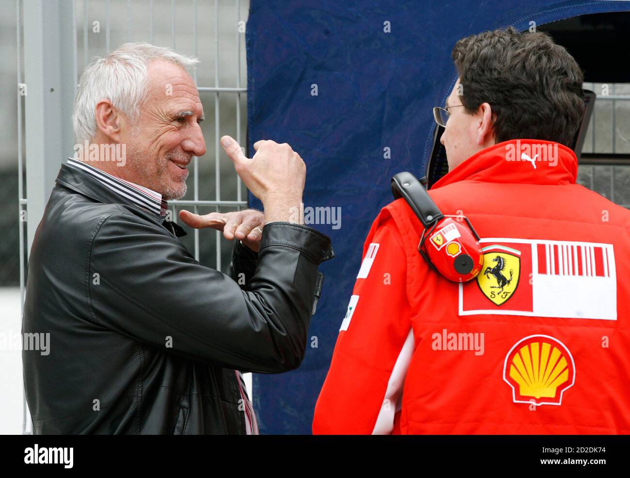 Red Bull owner Dietrich Mateschitz speaks to a Ferrari member.