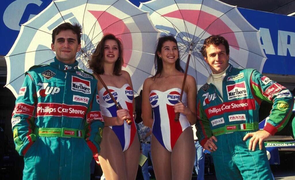 Andrea de Cesaris and Alessandro Zanardi ('Pepsi' Jordan-Ford 191) with two grid girls. Japanese GP, Suzuka, 1991.