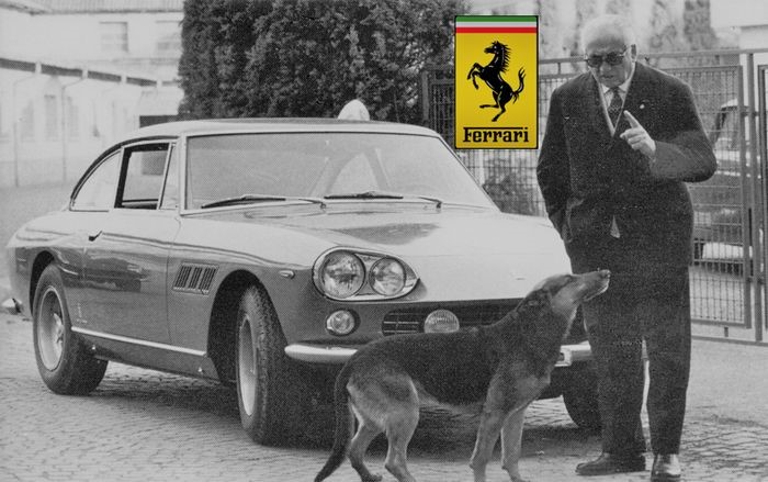 Enzo Ferrari with one of his Ferraris and a dog.