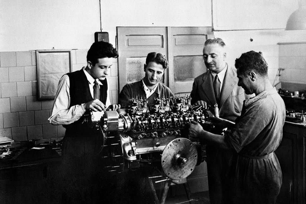 Enzo Ferrari with Colombo working with his team on a V12 engine in the late 1940s.