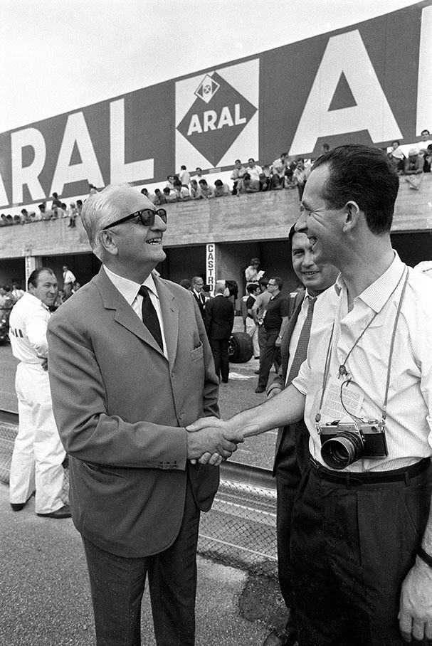 The British journalist and author John Blunsden shakes hands with Enzo Ferrari at Monza in 1968.