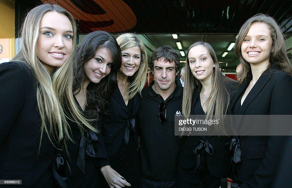 New Ferrari F1 driver Fernando Alonso poses with girls on 15.11.2009.