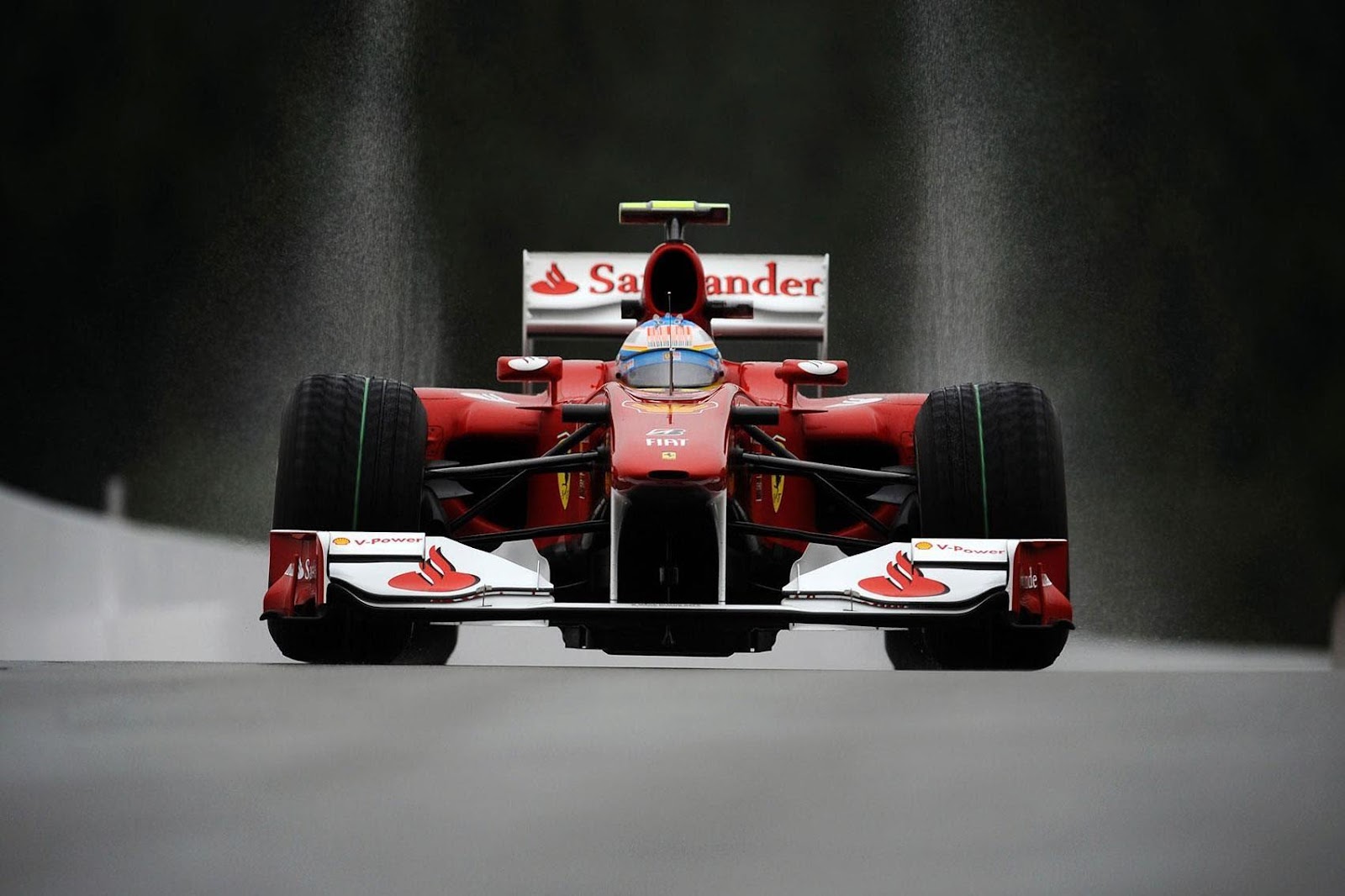 Fernando Alonso driving a Ferrari.