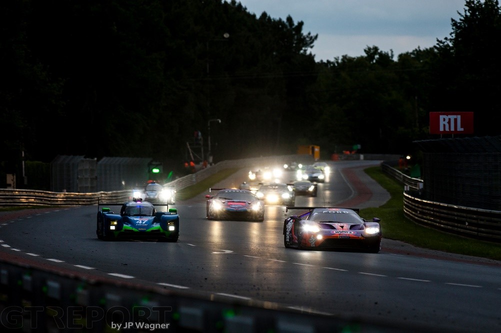 A race in Le Mans at night.