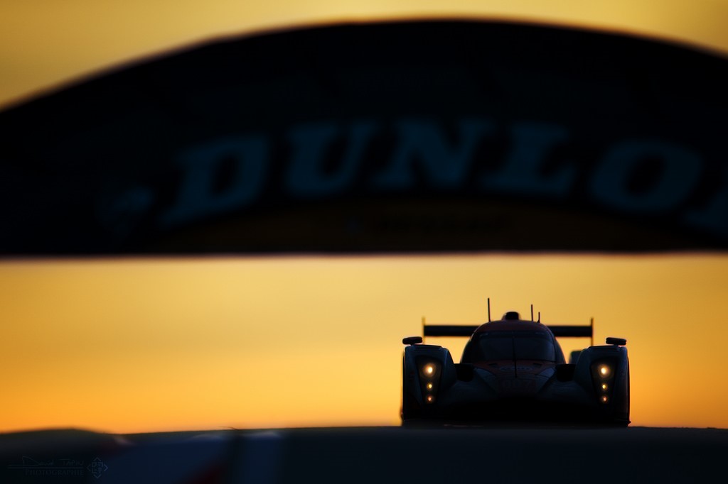 A racing car in Le Mans at night.