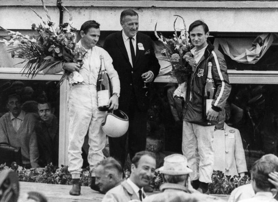 Henry Ford II poses with Ford drivers Bruce McLaren and Chris Amon, after their historic victory at the 1966 Le Mans. 