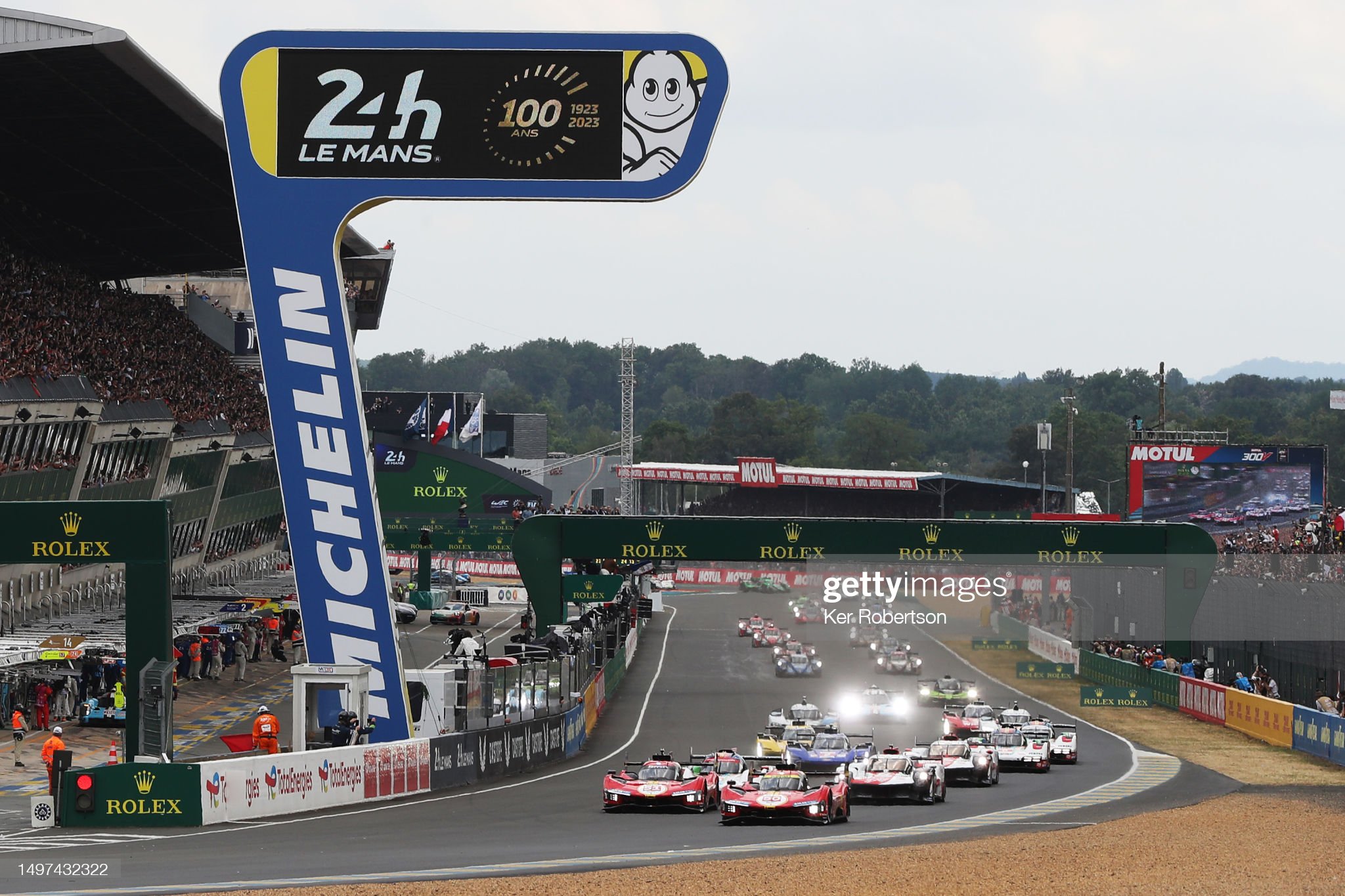 The Ferrari 499P of Nicklas Nielsen (front right) and the Ferrari 499P of James Calado (front left) lead the field at the start of the 100th anniversary 24 Hours of Le Mans race at the Circuit de la Sarthe on June 10, 2023 in Le Mans, France.