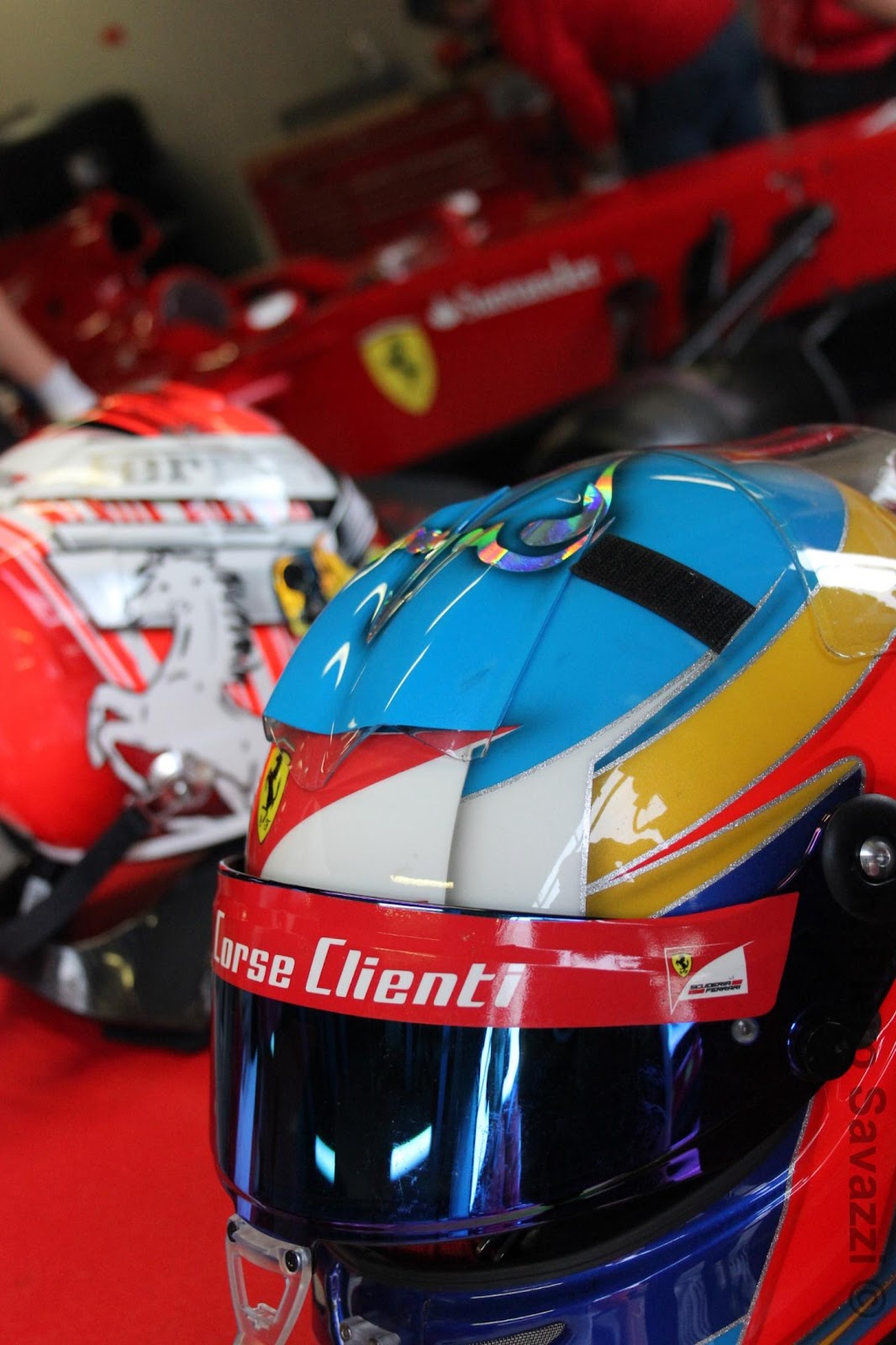 Photo of helmet on top of a Ferrari