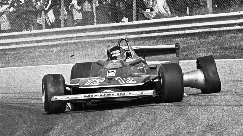 Gilles Villeneuve in his Ferrari with a destroyed tyre.