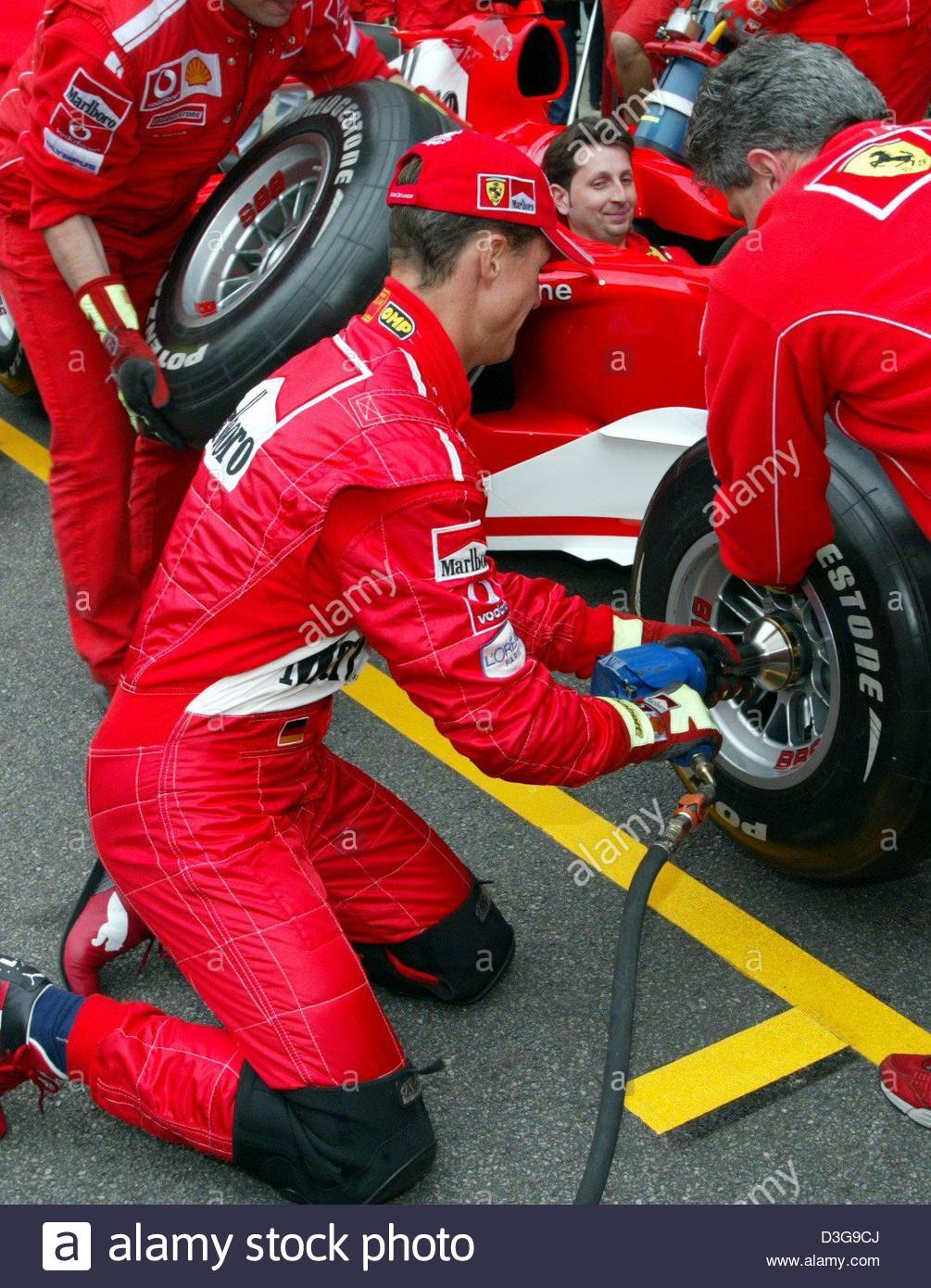 Michael Schumacher changing a tyre of his Ferrari F1.