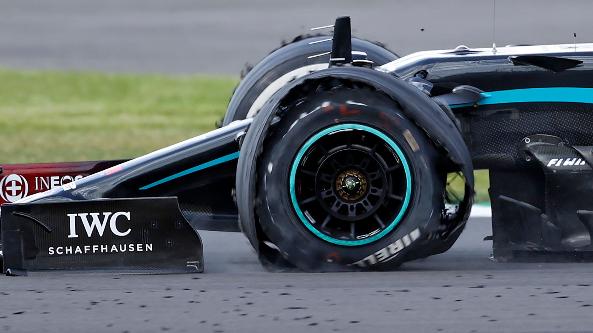 A F1 car with a destroyed tyre.