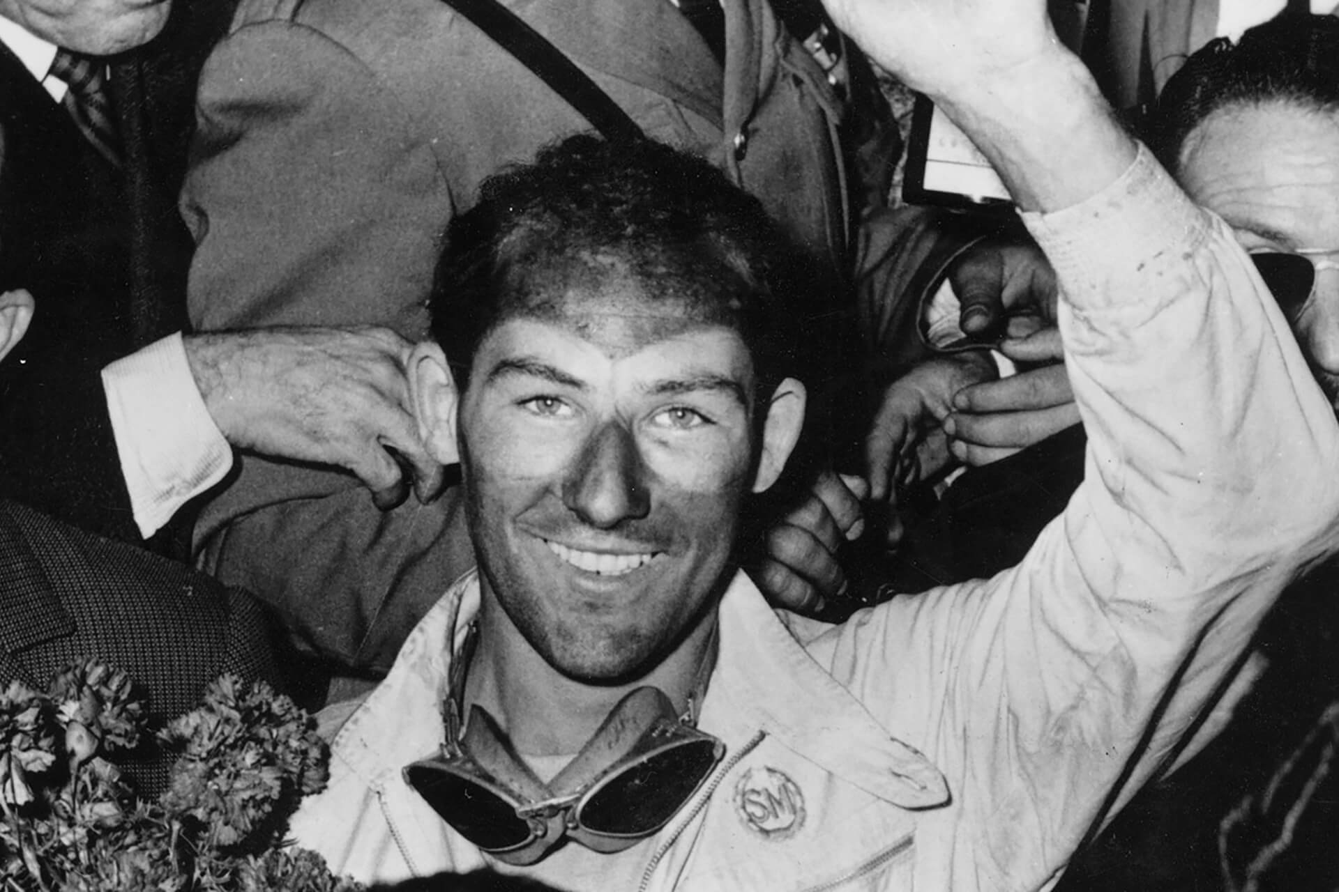 Stirling Moss celebrates winning the Mille Miglia in 1955. 