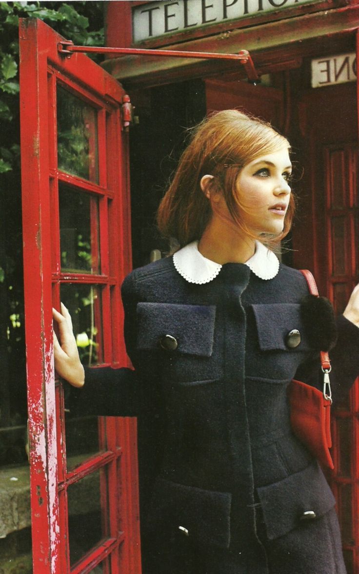 A girl in a London red phone box.