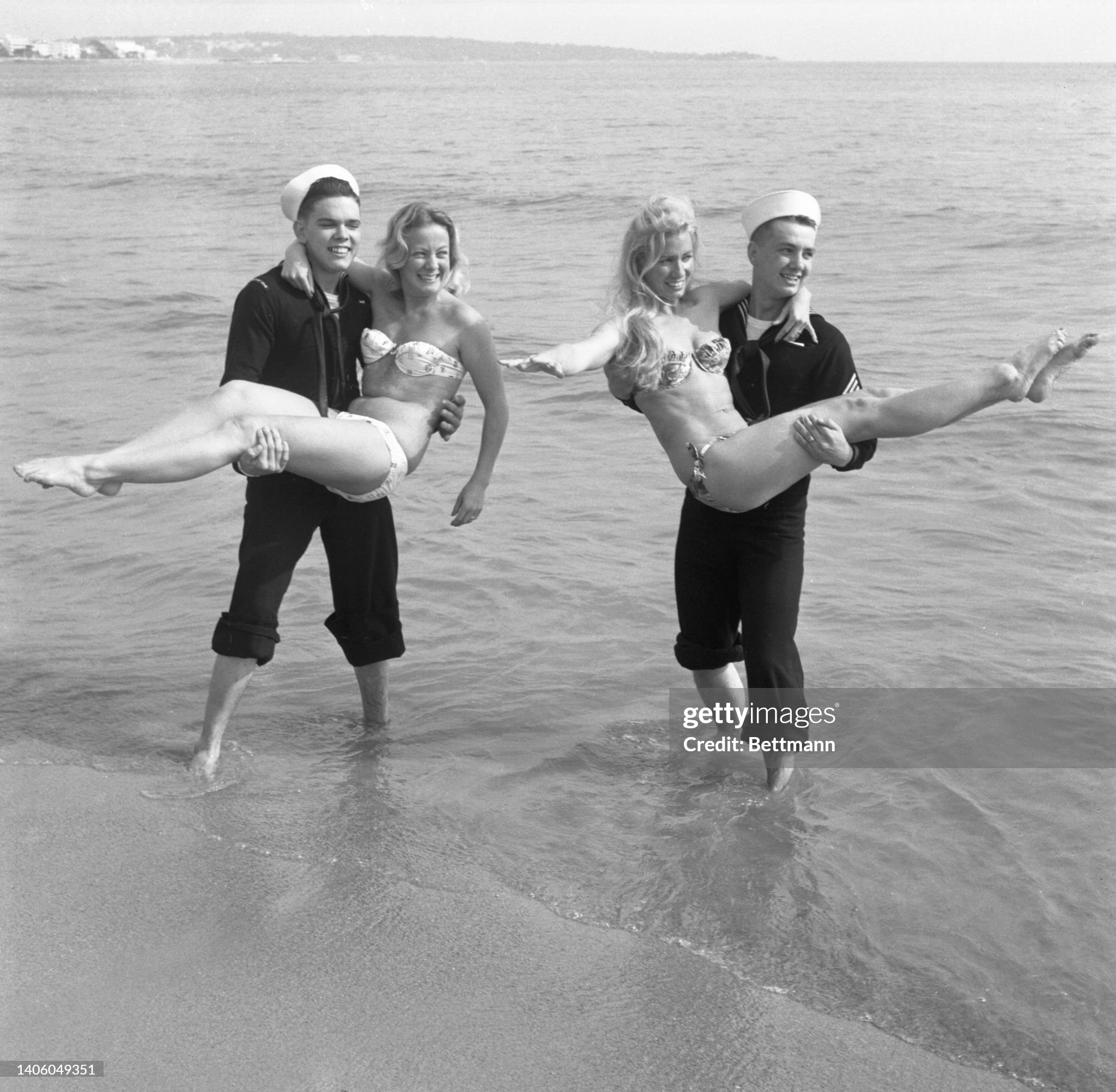 American sailors David Chime (left) and Thornton Bruce go for a romp in the surf with Josiane Vincent, the ex Miss Festival of Cannes and Lilou Paris on May 14, 1960. 