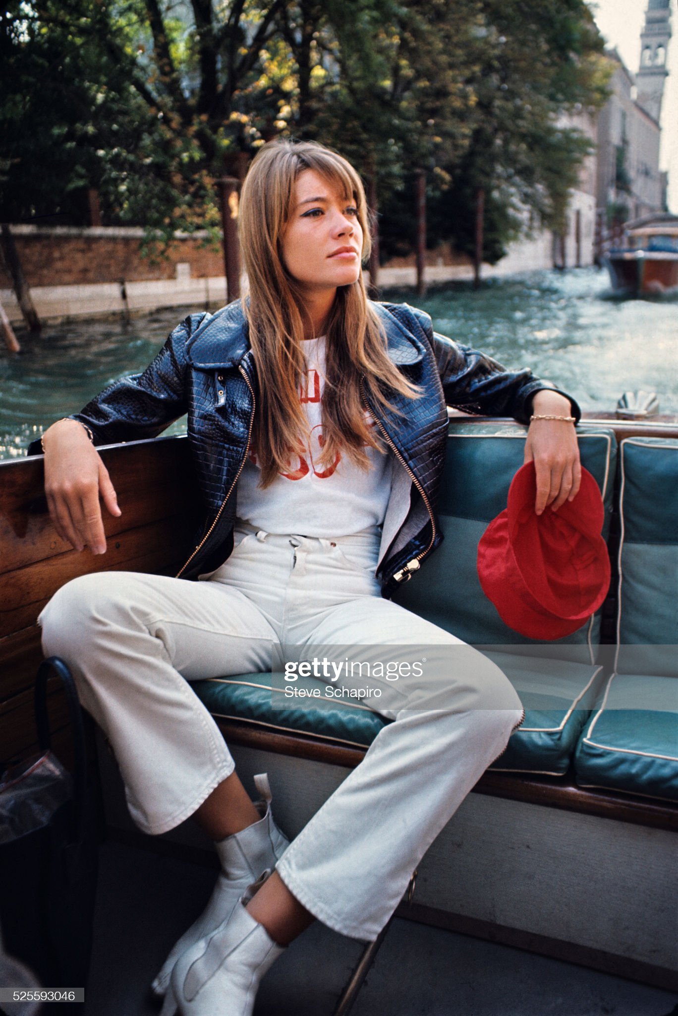 View of French pop musician and actress Françoise Hardy as she sits in a boat on a canal, Venice, Italy, September 1966. 